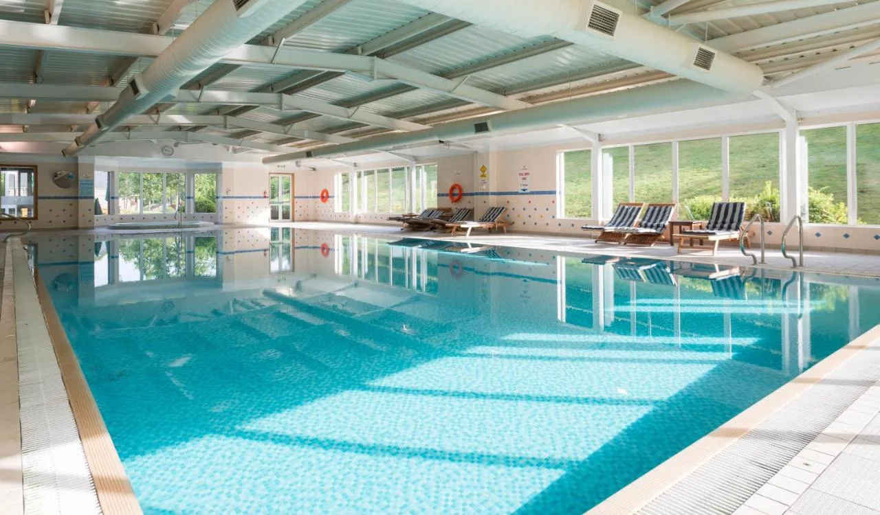 Large indoor swimming pool with blue water at Ardoe House Hotel & Spa in Blairs, Aberdeen