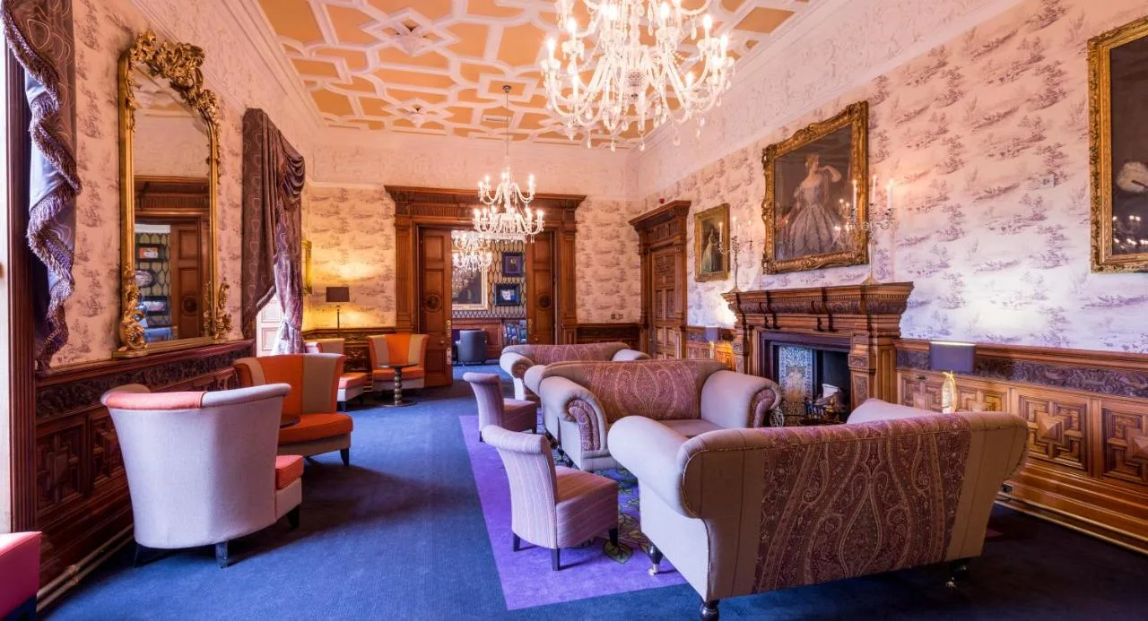 Cosy sitting room with armchairs and a fireplace at Ardoe House Hotel & Spa